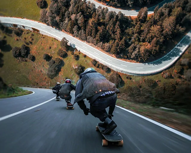 Longboarders racing down a winding mountain road